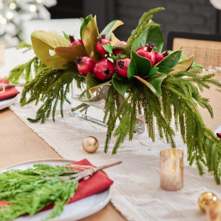 Lifelike Red Pomegranate, Real Touch Magnolia Leaves, and Norfolk Oval Vase Christmas Centerpiece
