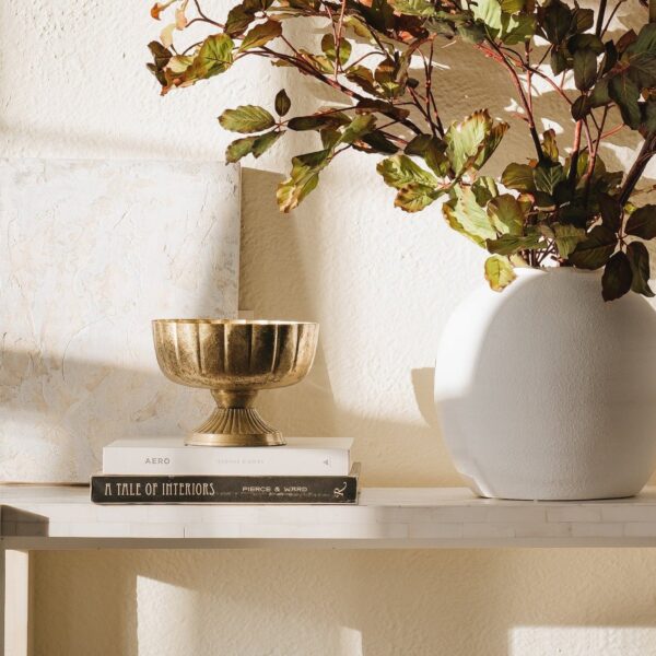 Close-up of vase silhouette detail on this Distressed Gold Metal Compote Bowl - 8 inch
