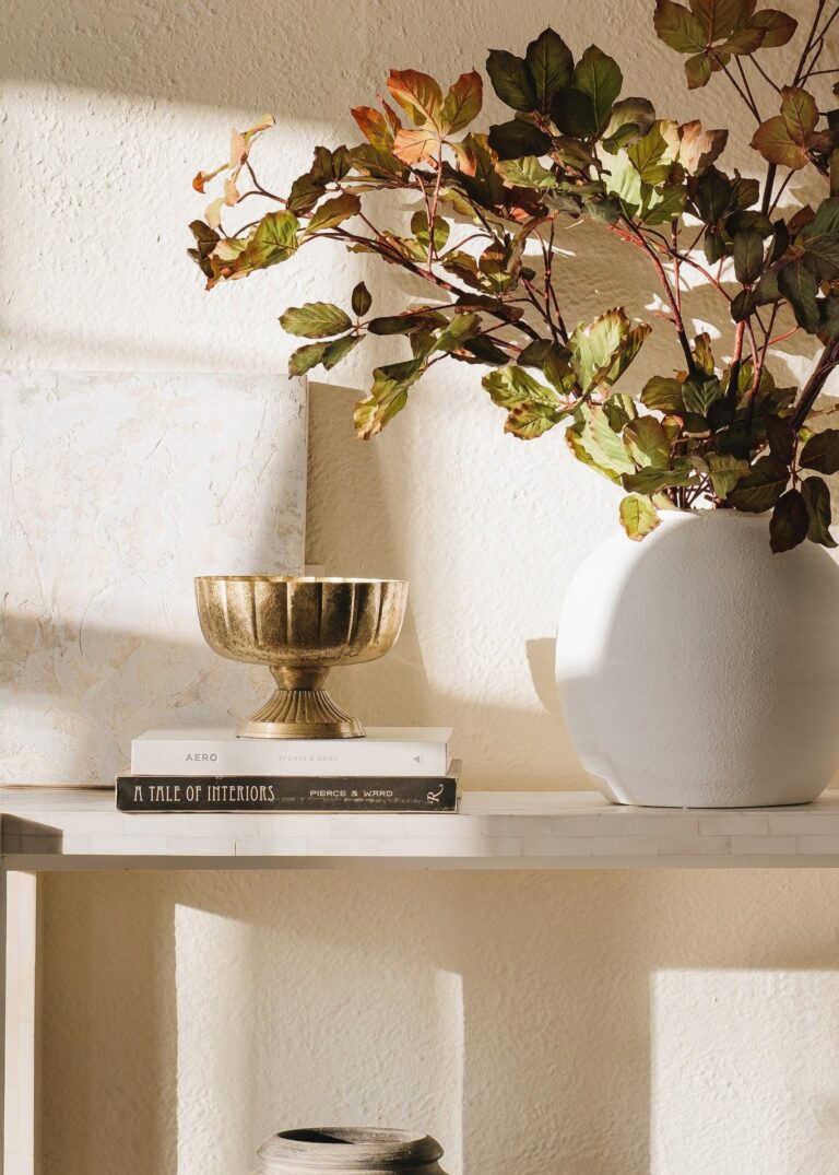 Close-up of vase silhouette detail on this Distressed Gold Metal Compote Bowl - 8 inch