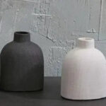 Alternate angle of the Modern Karis Ceramic Black Round Bud Vase showing bloom arrangement in