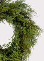 Close-up of blooms and berries on this Real Touch Boxwood and Pine Winter Greenery Wreath