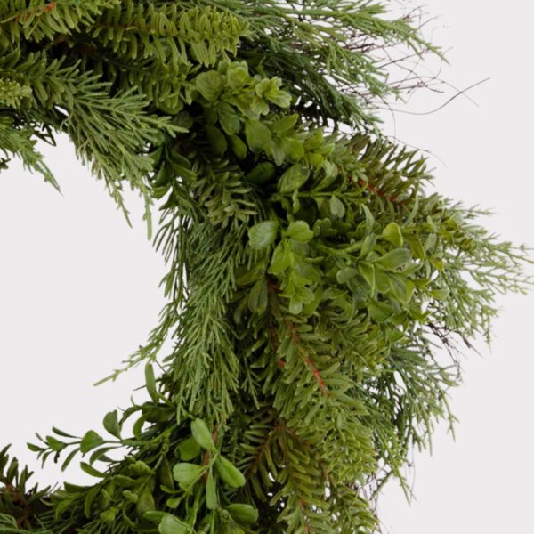 Close-up of blooms and berries on this Real Touch Boxwood and Pine Winter Greenery Wreath