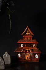 Side view of the Spooky Ceramic Ghost Haunted House House Luminary Candle revealing craft detail