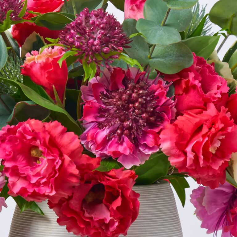 Close-up of vase silhouette detail on this Real Touch Fuchsia Scabiosa, Lisianthus Groove Cement Vase
