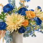 Alternate angle of the Blue Oblivion - Zinnia, Ranunculus Long Neck Vase showing bloom arrangement