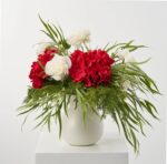 Alternate angle of the Home For The Holidays Christmas Centerpiece Arrangement showing bloom arrangement in