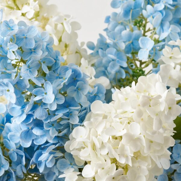 Close-up of vase silhouette detail on this Hampton's Breeze - Real Touch Large Centerpiece Arrangement