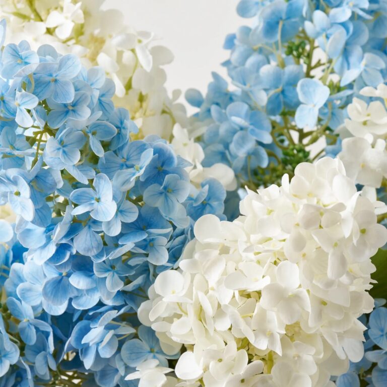 Close-up of vase silhouette detail on this Hampton's Breeze - Real Touch Large Centerpiece Arrangement