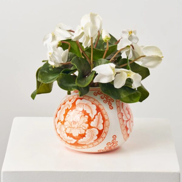 Close-up of vase silhouette detail on this White Cyclamen Leaf and Bloom Faux Floral Arrangement