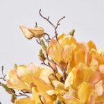 Close-up of vase silhouette detail on this Golden Yellow Magnolia Blooms Everyday Centerpiece Arrangement