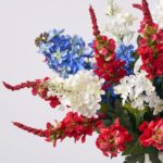 Close-up of vase silhouette detail on this Flower Fireworks - Red Delphinium, Matte Cream Vase