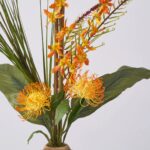 Close-up of bloom cluster detail on this Aloha Sunrise - Orange Orchid and Pincushion Protea
