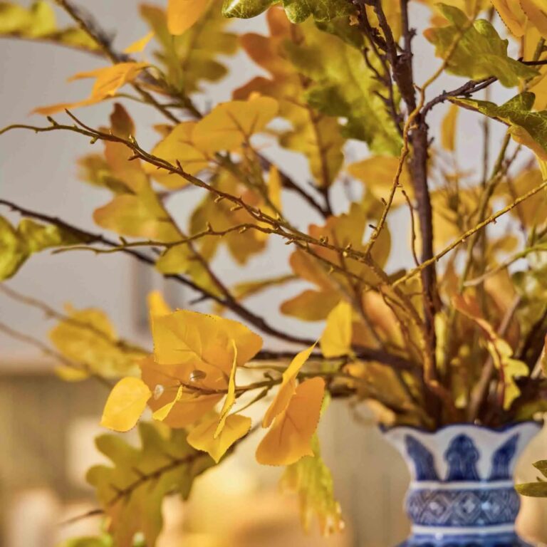 Close-up of bloom cluster detail on this Lifelike Autumn Green Oak Leaf Foliage Centerpiece Arrangement