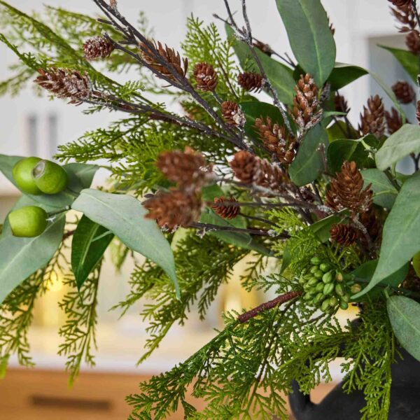 Close-up of bloom cluster detail on this Grand Yuletide - Lifelike Cedar Holiday Centerpiece Arrangement