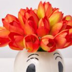 Close-up of bloom cluster detail on this Fiesta Skull - Mini Orange Pot Fall Arrangement