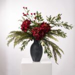 Alternate angle of the Tuscan Christmas - Deep Red Floral Centerpiece Arrangement showing full arrangement