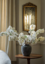 Alternate angle of the Distressed Rustic Concrete Vase - 12 inch Tall showing bloom arrangement