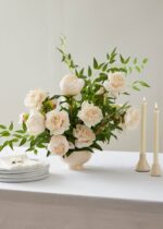 Alternate angle of the Beige Real Touch Duchess Rose Fake Flower - showing leaves along