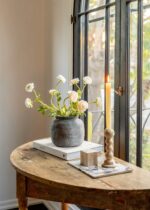 Alternate angle of the Distressed Rustic Concrete Vase - 7 inch Tall showing bloom arrangement