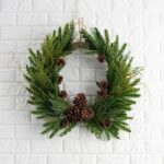 Close-up of blooms and berries on this Evergreen Forest Mixed Greens Crest Christmas Wreath