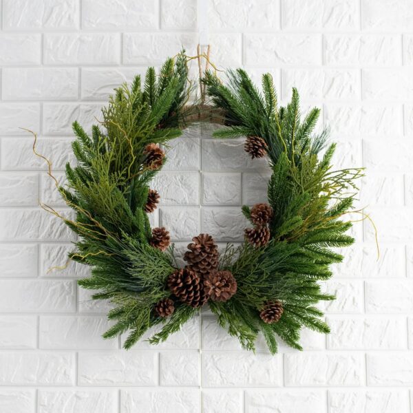 Close-up of blooms and berries on this Evergreen Forest Mixed Greens Crest Christmas Wreath