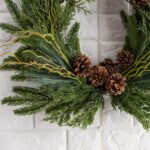 Side view of the Evergreen Forest Mixed Greens Crest Christmas Wreath revealing frame and backing