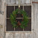 Detail view of layered greenery detail from the Evergreen Forest Mixed Greens Crest Christmas Wreath