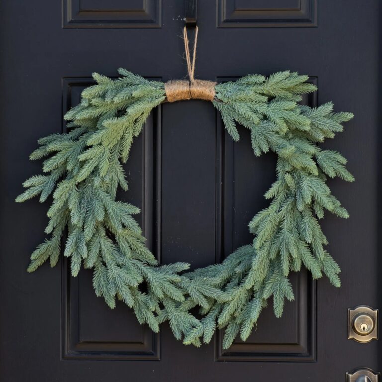Close-up of blooms and berries on this Down Swept Winter Holiday Evergreen Front Door Wreath