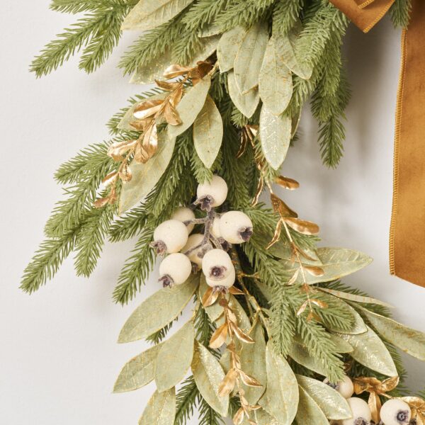Close-up of blooms and berries on this Downswept Fir Wreath with Gilded Door Holiday Wreath