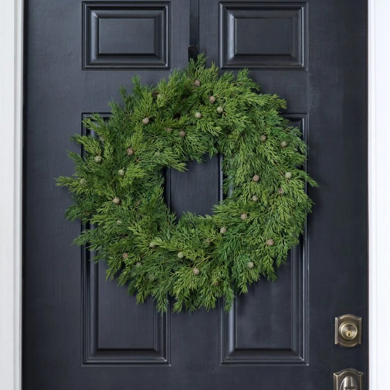 Close-up of blooms and berries on this Seeding Real Touch Juniper Berry Door Mantle Wreath