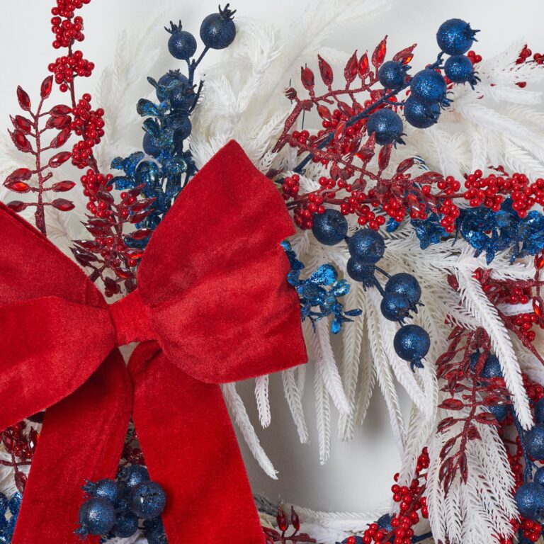Close-up of blooms and berries on this White Norfolk Pine, Red Berry Holiday Christmas Wreath
