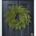 Alternate angle of the Real Touch Cedar Front Door Holiday Winter Wreath showing wreath face