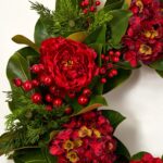 Close-up of blooms and berries on this Holiday Affair - Real Touch Door Christmas Wreath