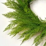 Close-up of blooms and berries on this Real Touch Lebanon Cedar Outdoor Front Door Wreath