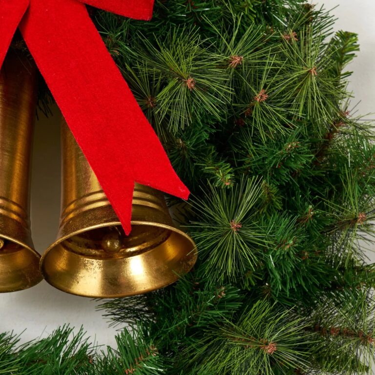 Close-up of blooms and berries on this Carol of the Bells Base Christmas Wreath