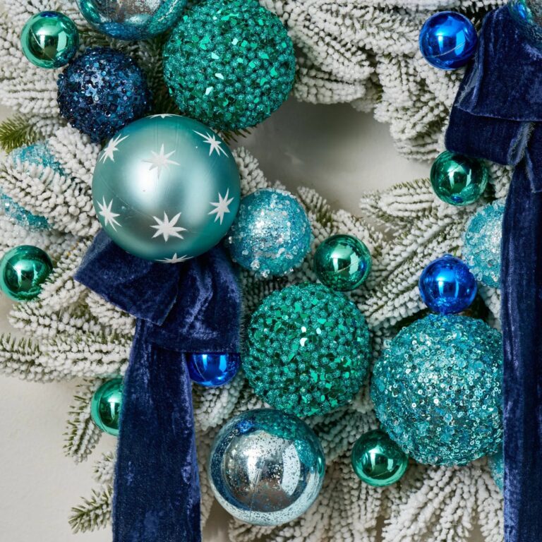 Close-up of blooms and berries on this Turquoise Twinkle - Mixed Blue Pine Christmas Wreath