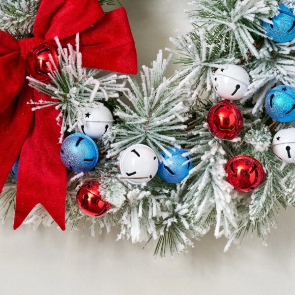Close-up of blooms and berries on this Americana Jingle Bells - Snowy Patriotic Holiday Wreath