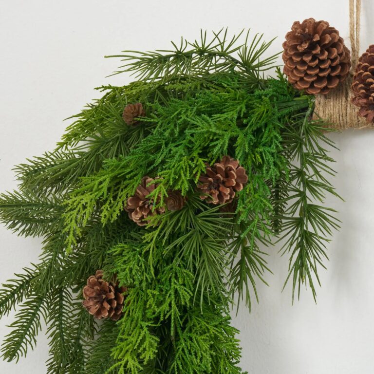Close-up of blooms and berries on this Evergreen Natural Touch Mixed Greenery Door Christmas Wreath