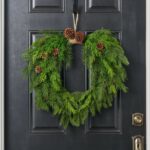 Alternate angle of the Evergreen Natural Touch Mixed Greenery Door Christmas Wreath showing wreath face