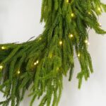 Close-up of blooms and berries on this Twinkling Norfolk - White Pre Christmas Holiday Wreath