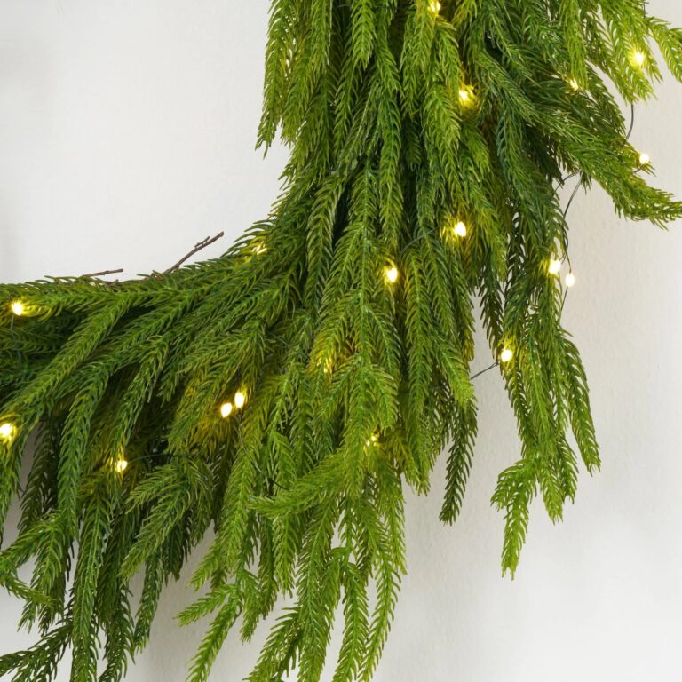 Close-up of blooms and berries on this Twinkling Norfolk - White Pre Christmas Holiday Wreath