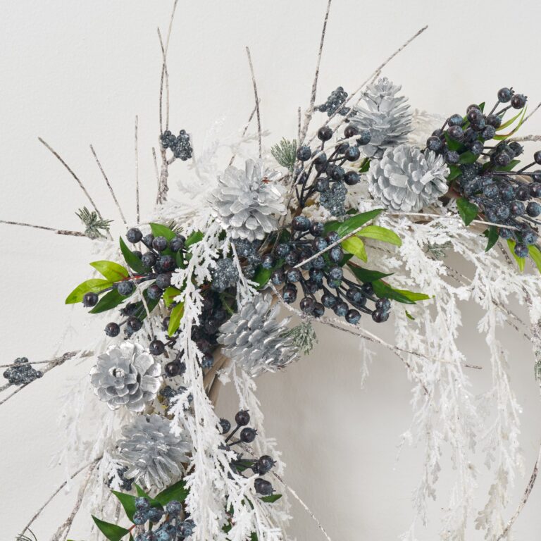 Close-up of blooms and berries on this Blue Winter Frost - White Front Door Wreath
