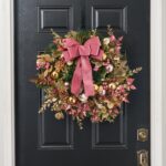 Alternate angle of the Merry Mauve Noel - Gold Front Door Wreath showing wreath face
