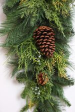 Alternate angle of the Classic Holiday Greens and Pinecone Door Winter Swag showing full swag