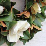 Side view of the Classic Real Touch White Magnolia Front Door Wreath revealing frame and