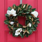 Detail view of layered greenery detail from the Classic Real Touch White Magnolia Front Door