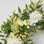 Close-up of blooms and berries on this Cream and Green Hydrangea, Ranunculus, Front Door Wreath