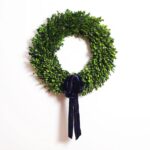 Detail view of layered greenery detail from the Natural Preserved Green Boxwood Wreath with Velvet