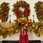 The Real Touch Magnolia Leaf Door Christmas Swag Holiday shown in full, highlighting swag tail