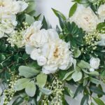 Close-up of blooms and berries on this White Peony, Ranunculus, Lamb's Ear, Front Door Wreath